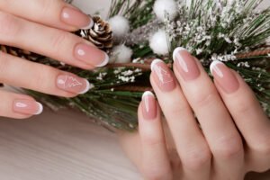 Snow White manicure on female hands. Winter nail design. Picture taken in the studio on a background of wool.